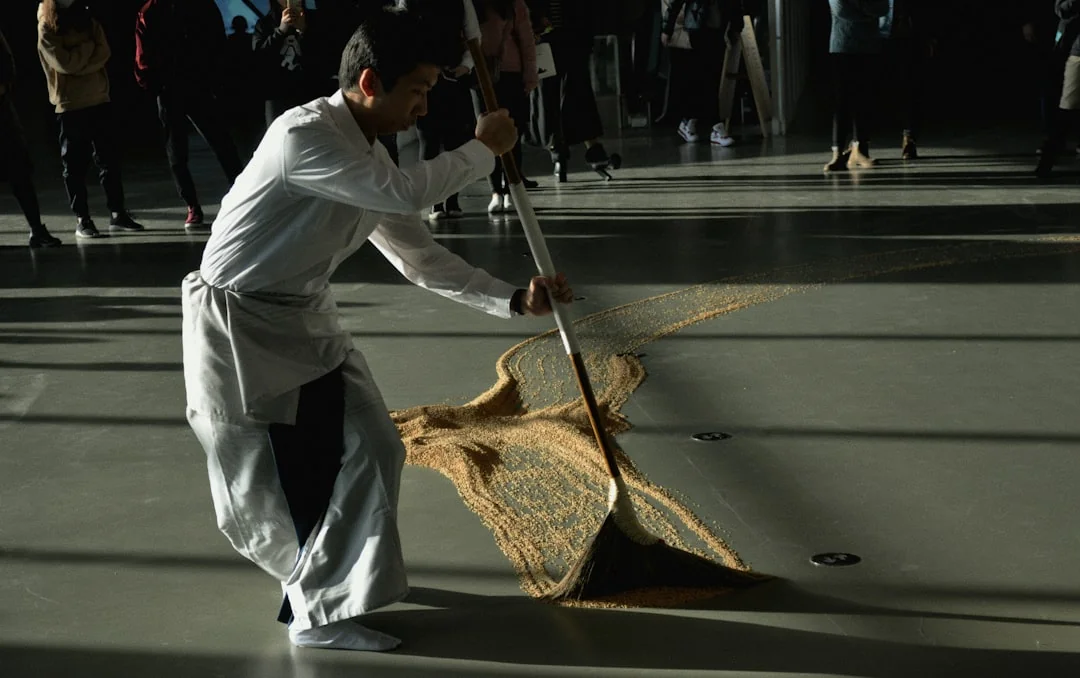 Professional housekeeper straightens a bed in a luxurious hotel room.